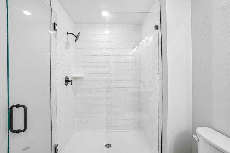 The primary bathroom features a frameless walk-in shower The primary bathroom features a frameless walk-in shower