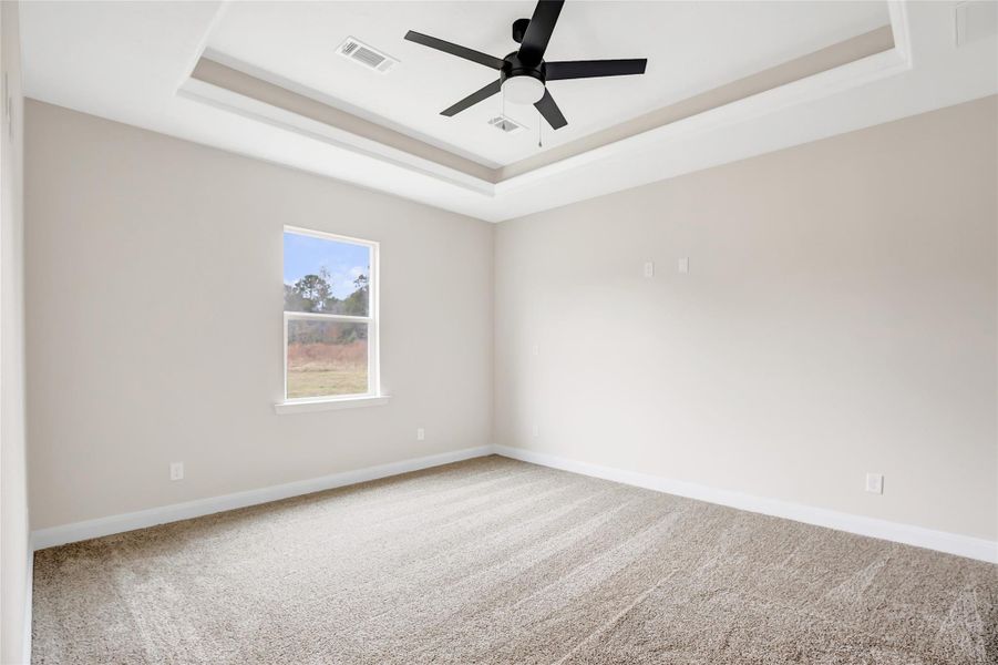 Primary bedroom located on first floor behind kitchen with back yard view. Split floor plan. Great location for mom and dad!