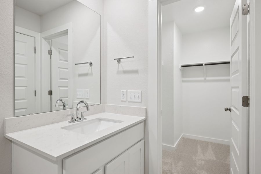 A bathroom with a sink and a mirror.