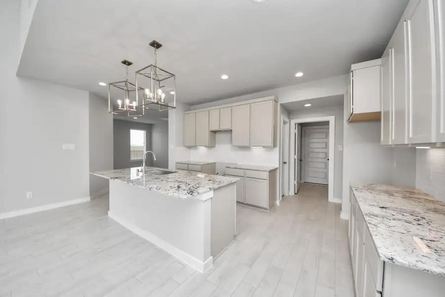 The open concept effortlessly connects the kitchen to the expansive family room, forming a perfect hub for gatherings. This seamless flow creates an inviting space where cooking and socializing come together harmoniously. Sample photo of completed home with similar floor plan. Actual colors and selections may vary.