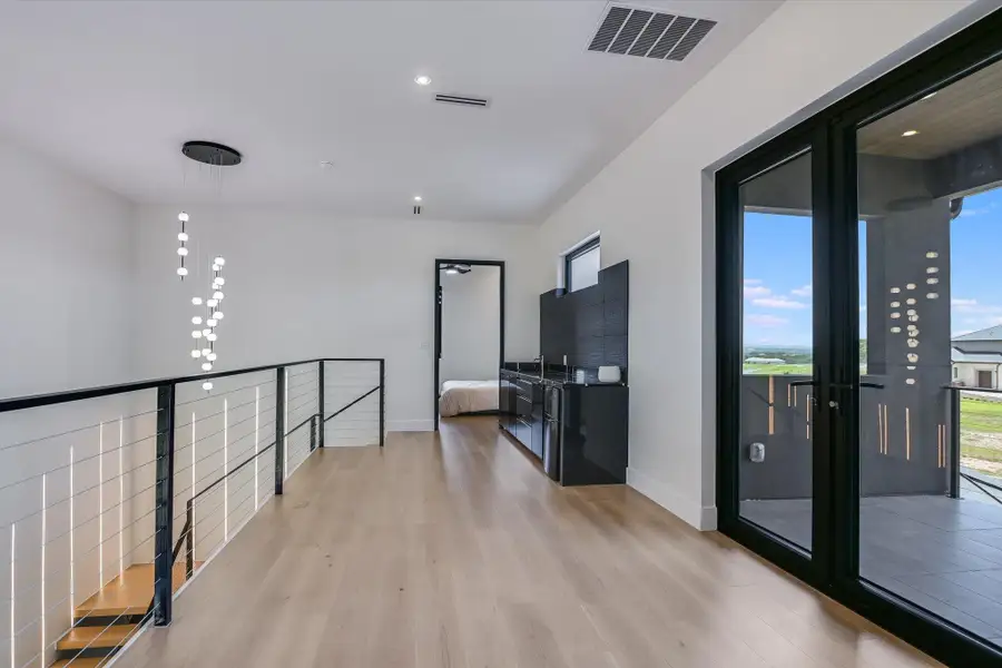 Upstairs hall featuring light wood-style flooring, plenty of natural light, and recessed lighting, built in sink and snack area Upstairs hall featuring light wood-style flooring, plenty of natural light, and recessed lighting, built in sink and snack area