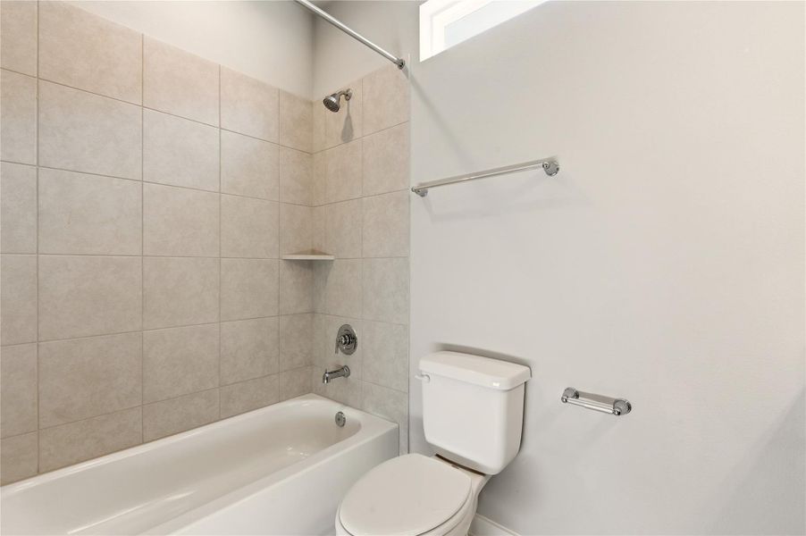 Bathroom featuring  shower combination and toilet