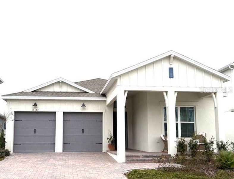 Front exterior of a new home in Horizon Isle, Winter Garden, FL, highlighting curb appeal (Image 2). Front exterior of a new home in Horizon Isle, Winter Garden, FL, highlighting curb appeal (Image 2).