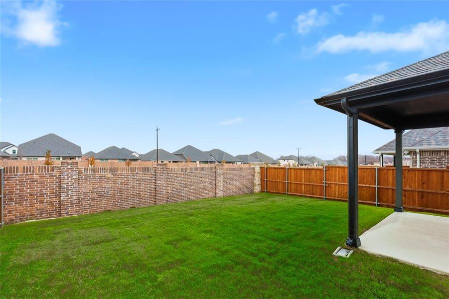 Fenced backyard featuring a residential view and a patio