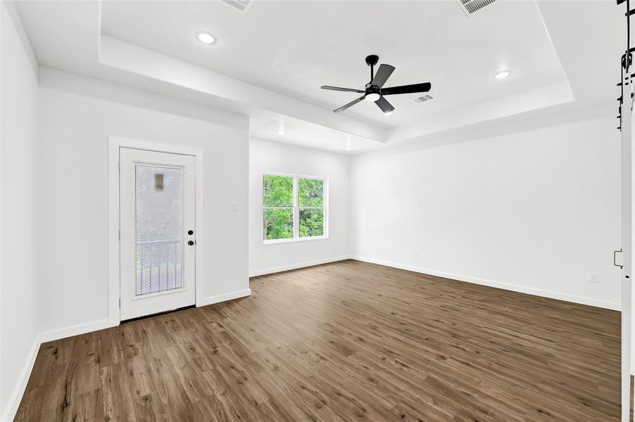 Large primary suite with tray ceiling and plenty of natural light. Large primary suite with tray ceiling and plenty of natural light.