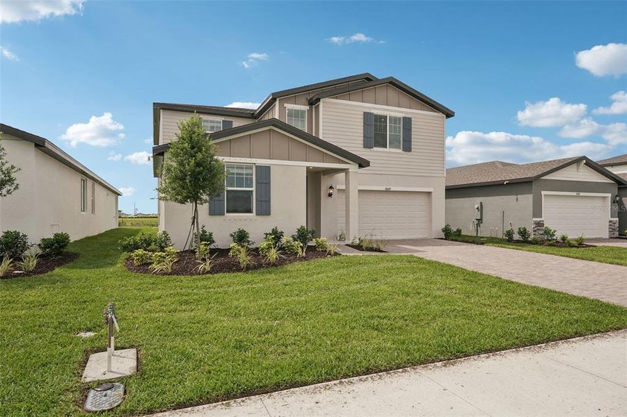Front exterior of a new home in Oakfield Trails - Classic Series, Parrish, FL, highlighting curb appeal (Image 19). Front exterior of a new home in Oakfield Trails - Classic Series, Parrish, FL, highlighting curb appeal (Image 19).