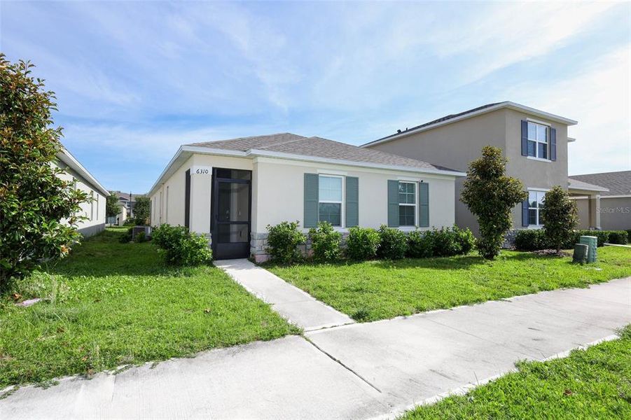 Front exterior of a new home in Windrose, Apopka, FL, highlighting curb appeal (Image 22).