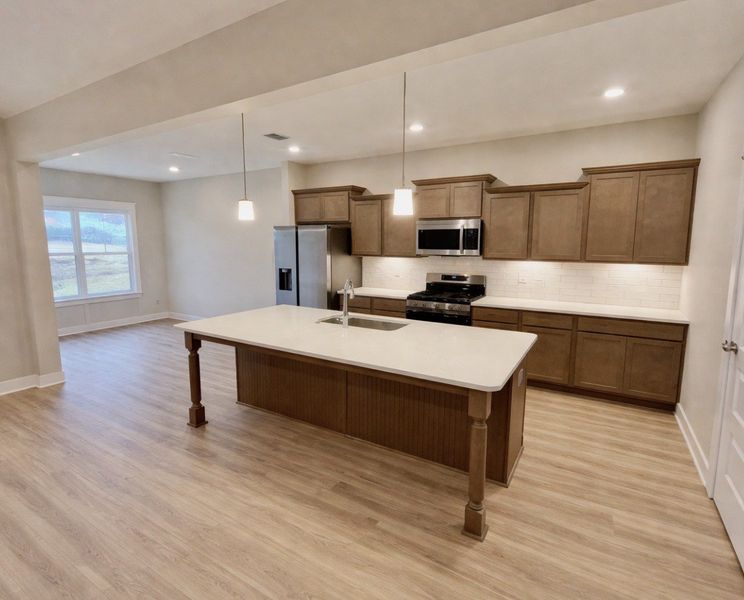 STOCK PHOTO: Home has a large kitchen island and separate eating nook off to the side!