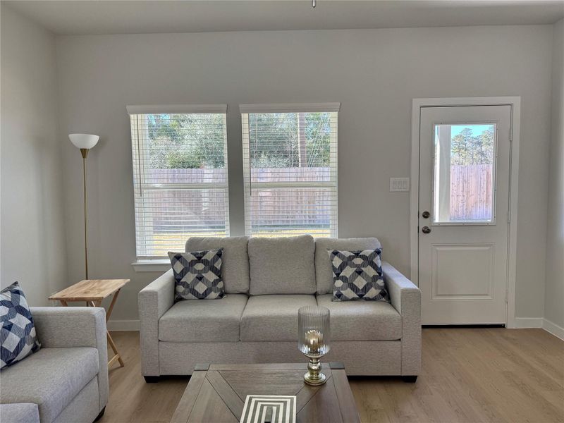 Bright, modern living room with neutral tones, featuring ample natural light from large windows and a wooded view to the reserve. Bright, modern living room with neutral tones, featuring ample natural light from large windows and a wooded view to the reserve.