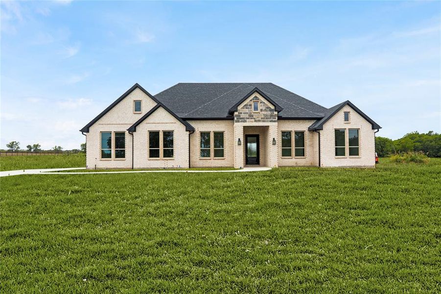 View of front of house with a front lawn and brick siding View of front of house with a front lawn and brick siding