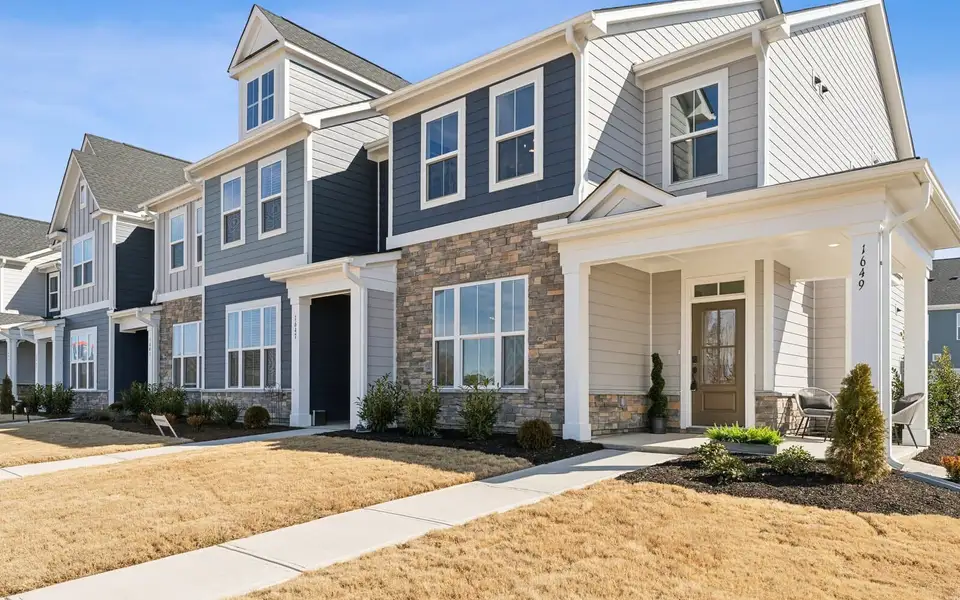 Front exterior of a new home in Wendell Falls, Wendell, NC, highlighting curb appeal (Image 2). Front exterior of a new home in Wendell Falls, Wendell, NC, highlighting curb appeal (Image 2).