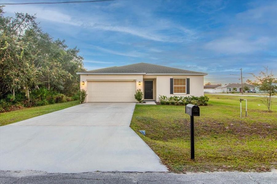 Front exterior of a new home in Poinciana, Poinciana, FL, highlighting curb appeal (Image 2). Front exterior of a new home in Poinciana, Poinciana, FL, highlighting curb appeal (Image 2).