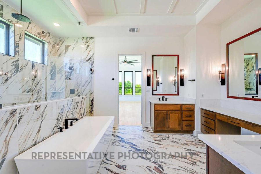 Bathroom featuring light marble finish floors, a freestanding bath, vanity, a marble finish shower, and a ceiling fan Bathroom featuring light marble finish floors, a freestanding bath, vanity, a marble finish shower, and a ceiling fan