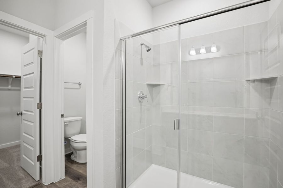 A bathroom with a glass shower. A bathroom with a glass shower.