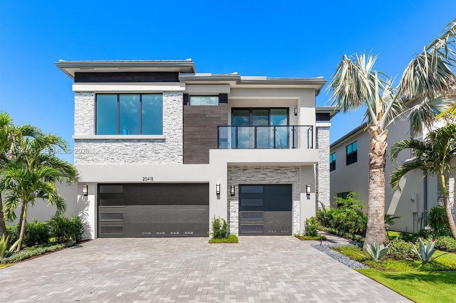 Front exterior of a new home in Lotus Edge, Boca Raton, FL, highlighting curb appeal (Image 2). Front exterior of a new home in Lotus Edge, Boca Raton, FL, highlighting curb appeal (Image 2).