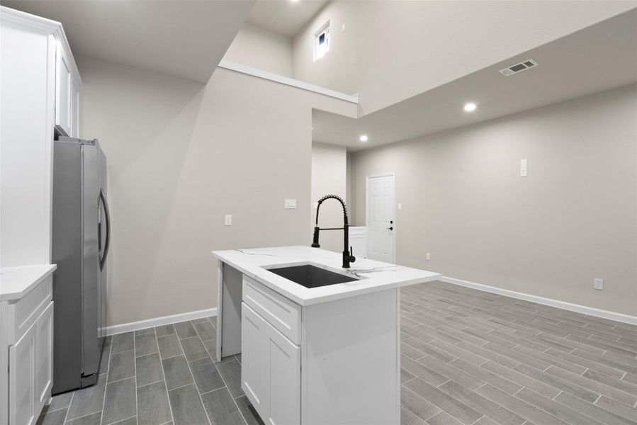 Black fixture feaatures, sink island with Quartz marble and ceramic tile flooring Black fixture feaatures, sink island with Quartz marble and ceramic tile flooring