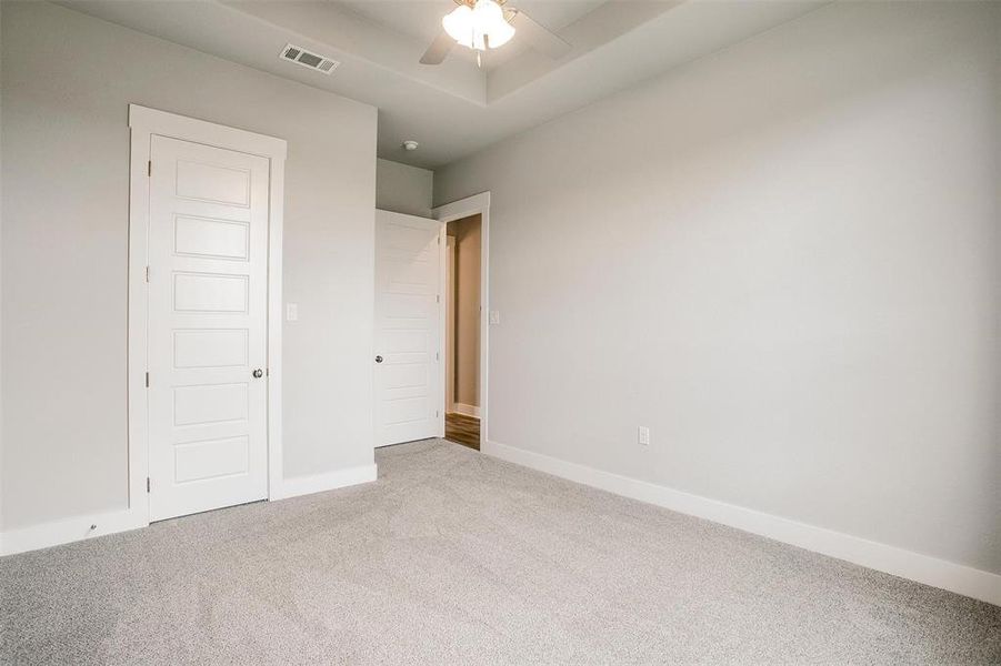 Spare room featuring carpet floors and ceiling fan