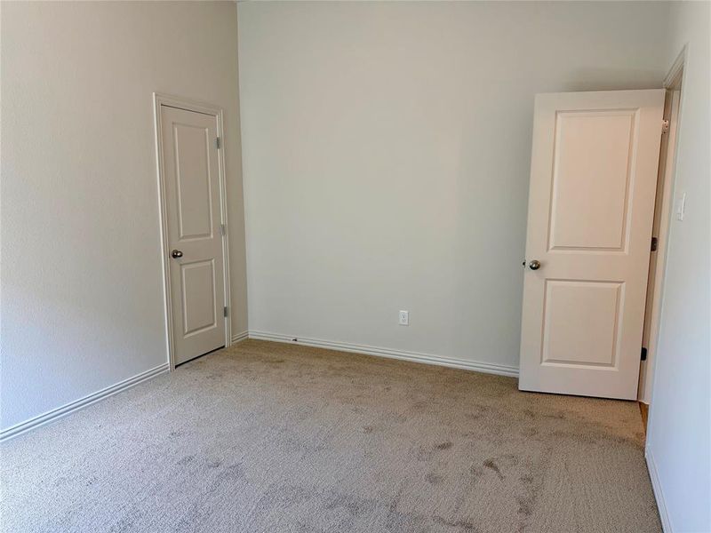 Neutral-toned carpeting paired with light walls and white trim