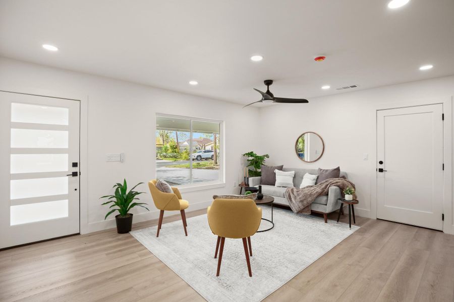 Living room with recessed lighting, light wood finished floors, and ceiling fan