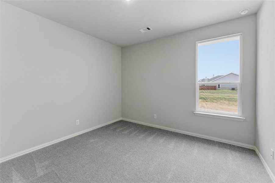 Spare room with light carpet and baseboards