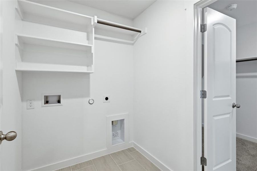 Laundry room with washer hookup, hookup for an electric dryer, and hookup for a gas dryer