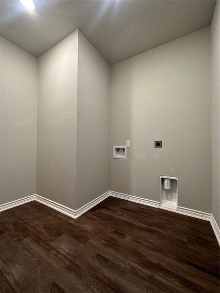 Washroom featuring electric dryer hookup, dark wood-type flooring, and washer hookup