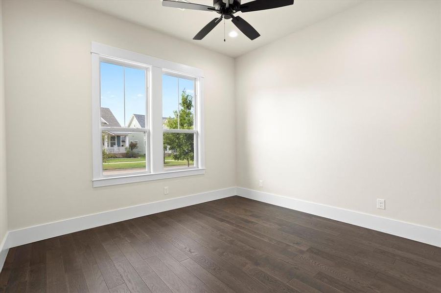 Spare room featuring ceiling fan and dark hardwood / wood-style floors