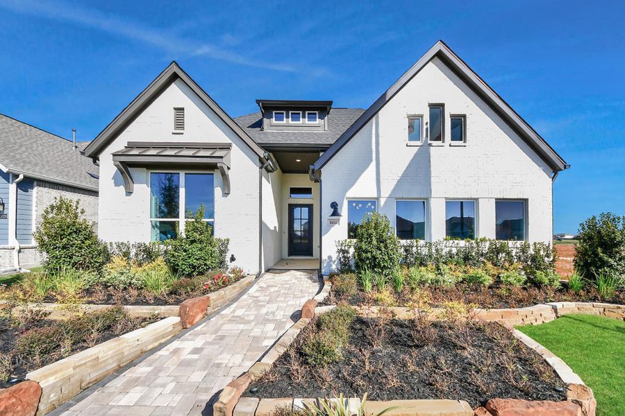 Front exterior of a new home in Meridiana Courtyard Collection, Manvel, TX, highlighting curb appeal (Image 2). Front exterior of a new home in Meridiana Courtyard Collection, Manvel, TX, highlighting curb appeal (Image 2).