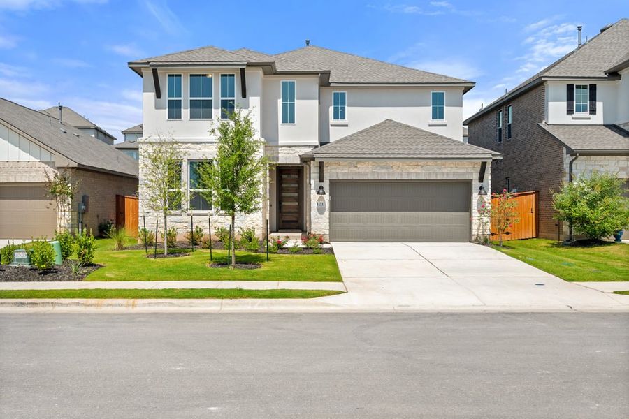 Front exterior of a new home in Park Collection at Lariat, Liberty Hill, TX, highlighting curb appeal (Image 2). Front exterior of a new home in Park Collection at Lariat, Liberty Hill, TX, highlighting curb appeal (Image 2).