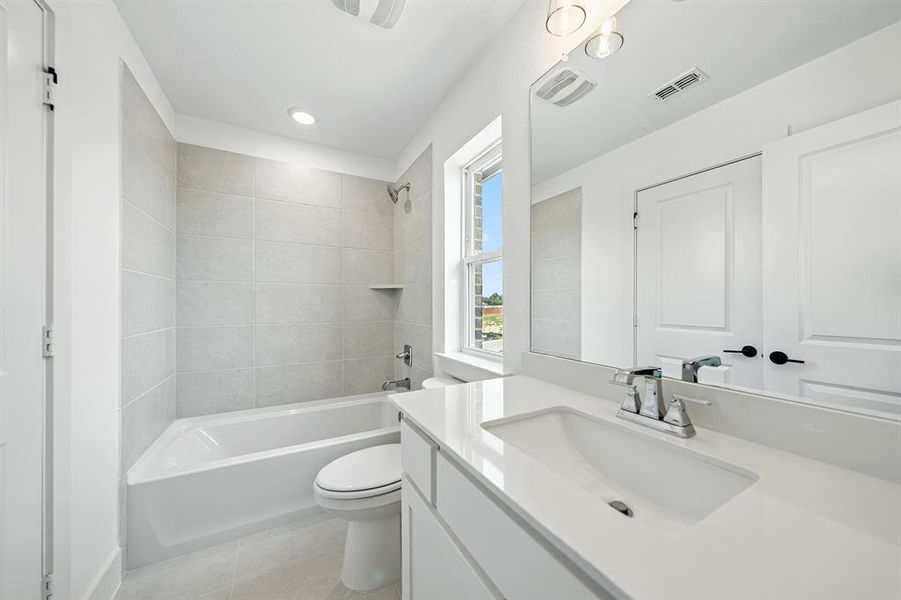 Full bath with vanity, shower / bathtub combination, light tile patterned flooring, and recessed lighting
