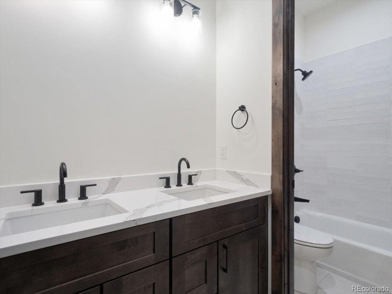 Upper level shared bath with bedroom two and three Upper level shared bath with bedroom two and three