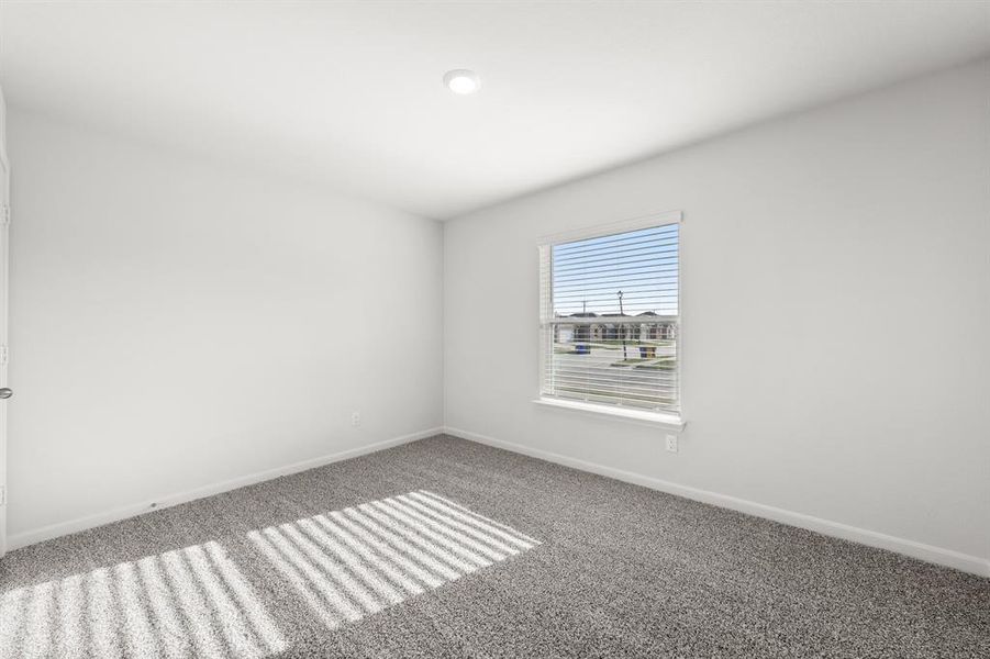 Spare room featuring carpet flooring