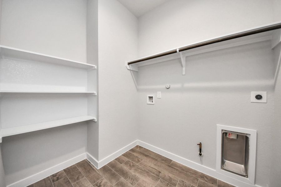 A perfect blend of functionality and comfort. Capture the essence of easy living with a first-floor laundry room, thoughtfully equipped with shelving for effortless organization. Both electric and gas connections available. A perfect blend of functionality and comfort. Capture the essence of easy living with a first-floor laundry room, thoughtfully equipped with shelving for effortless organization. Both electric and gas connections available.