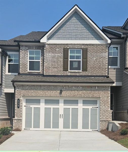 Front exterior of a new home in Towns at Holly Springs, Holly Springs, GA, highlighting curb appeal (Image 1). Front exterior of a new home in Towns at Holly Springs, Holly Springs, GA, highlighting curb appeal (Image 1).