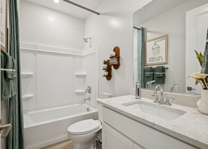A bathroom with a sink toilet and bathtub. A bathroom with a sink toilet and bathtub.