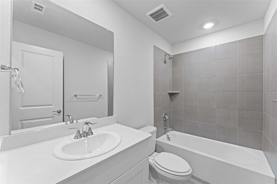 Full bathroom featuring vanity and shower / tub combination Full bathroom featuring vanity and shower / tub combination