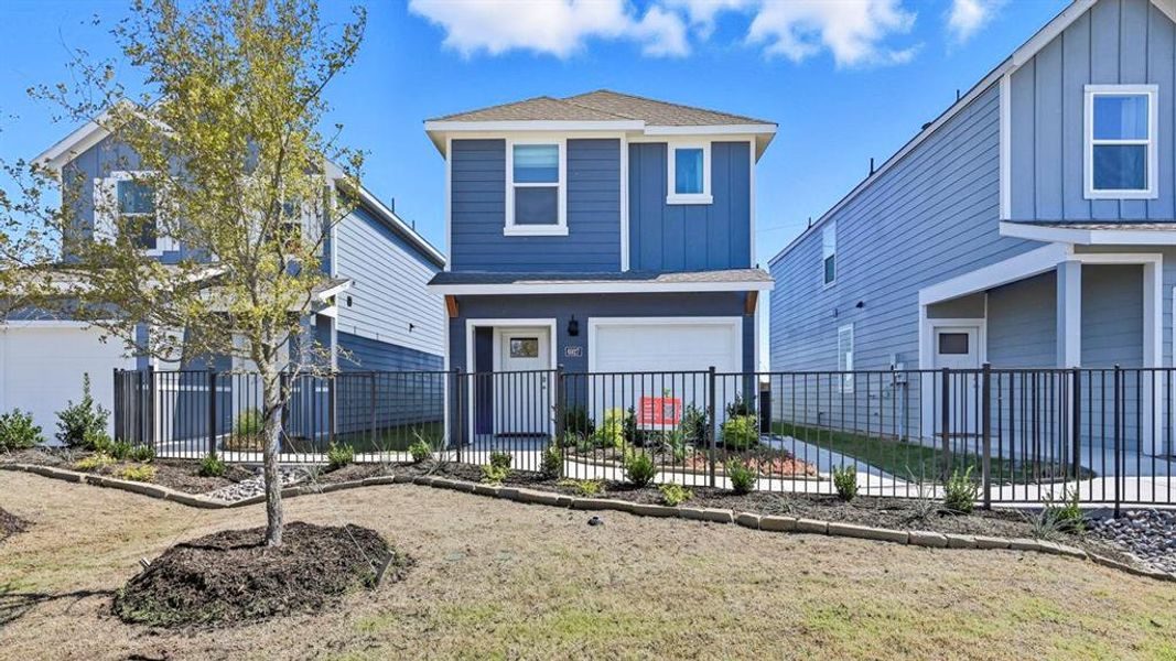 Traditional-style home featuring a shingled roof, board and batten siding, and a garage
