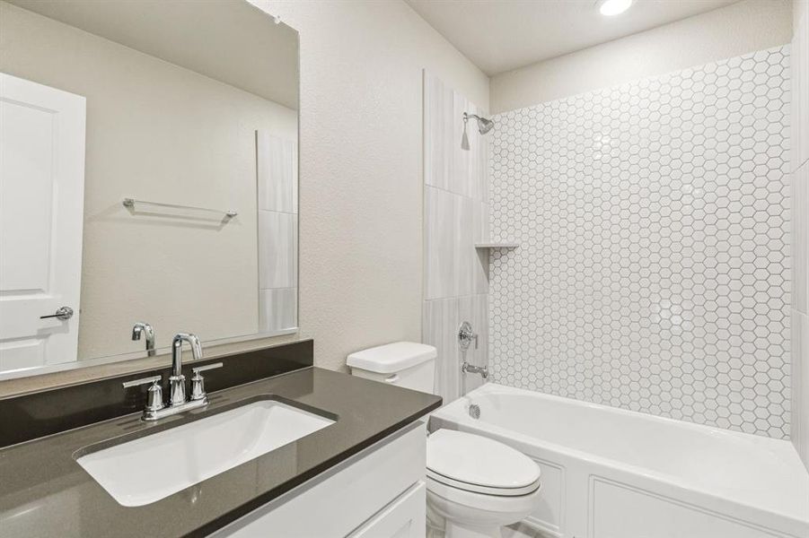 Full bath featuring  shower combination and vanity