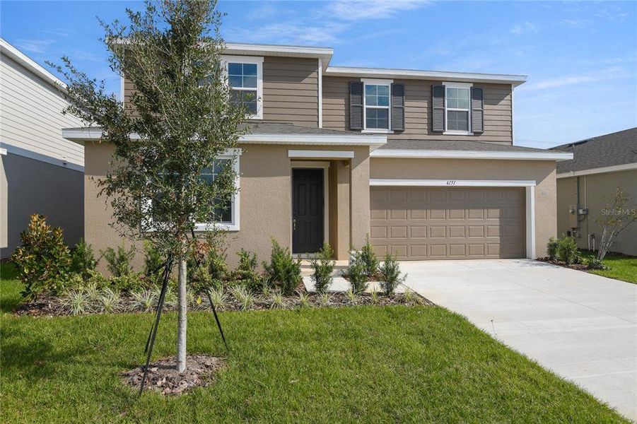 Front exterior of a new home in Seasons at Scenic Terrace, Lake Hamilton, FL, highlighting curb appeal (Image 2). Front exterior of a new home in Seasons at Scenic Terrace, Lake Hamilton, FL, highlighting curb appeal (Image 2).