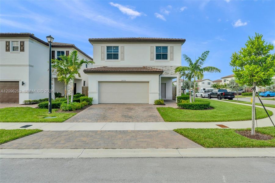 Front exterior of a new home in , Homestead, FL, highlighting curb appeal (Image 2). Front exterior of a new home in , Homestead, FL, highlighting curb appeal (Image 2).