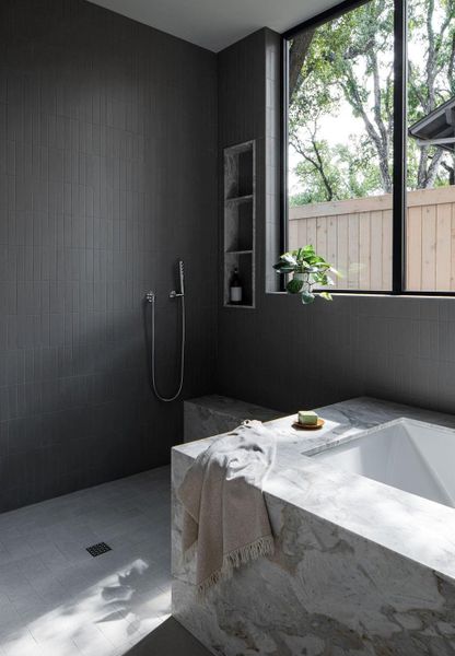 Incredible shower and tub in the primary bath. Elevated with elegant dolomite stone and luxury tile throughout.