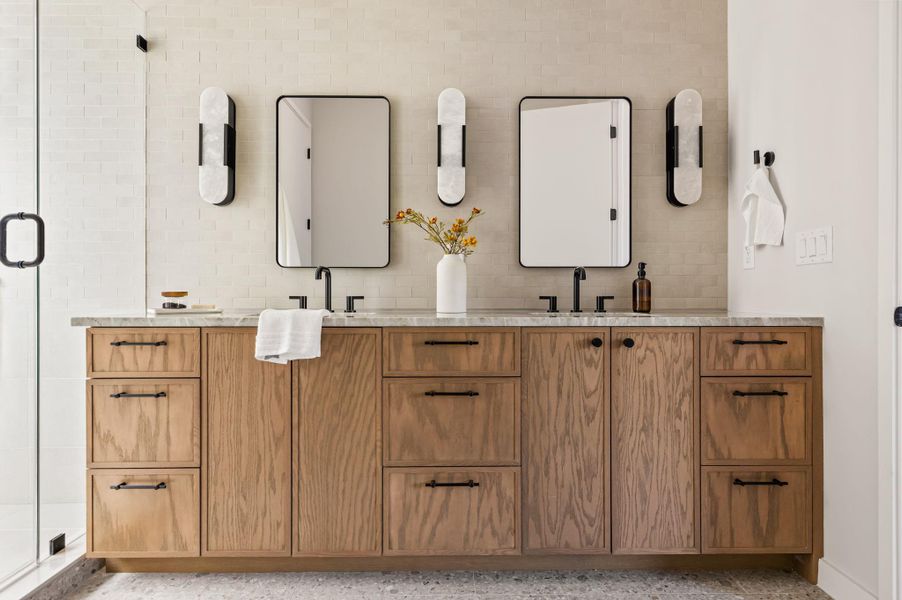 Double vanity sinks and stone countertops accent this beautifully designed contemporary bathroom. Double vanity sinks and stone countertops accent this beautifully designed contemporary bathroom.