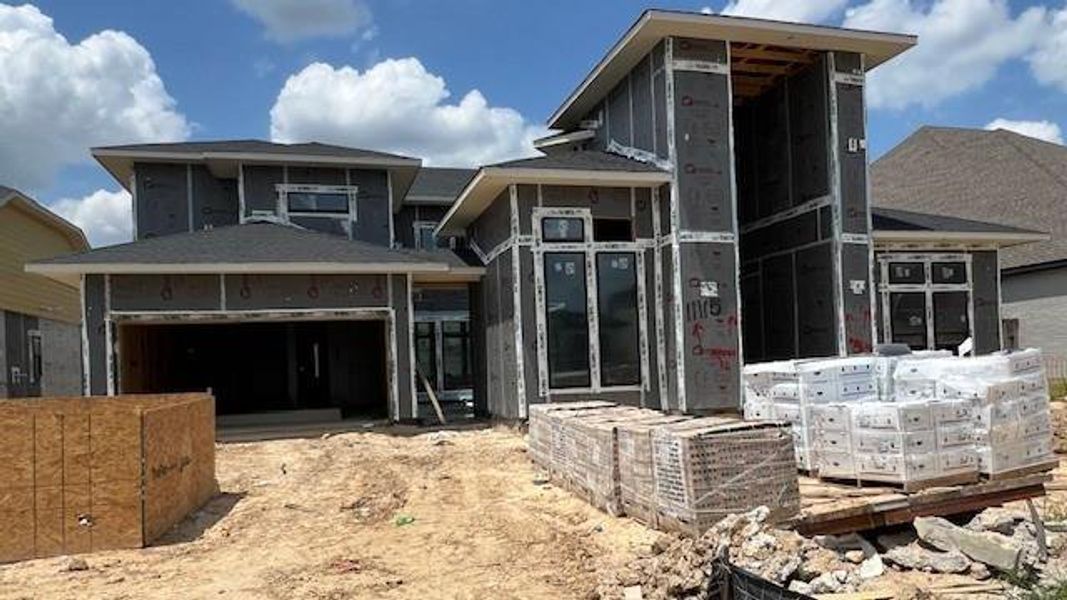 Front exterior of a new home in Bridgeland 45', 50', 70', Cypress, TX, highlighting curb appeal (Image 4). Front exterior of a new home in Bridgeland 45', 50', 70', Cypress, TX, highlighting curb appeal (Image 4).
