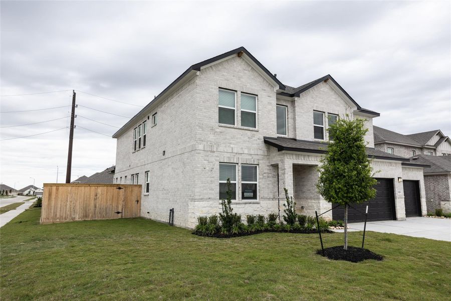 Front exterior of a new home in Ashland, Angleton, TX, highlighting curb appeal (Image 14).