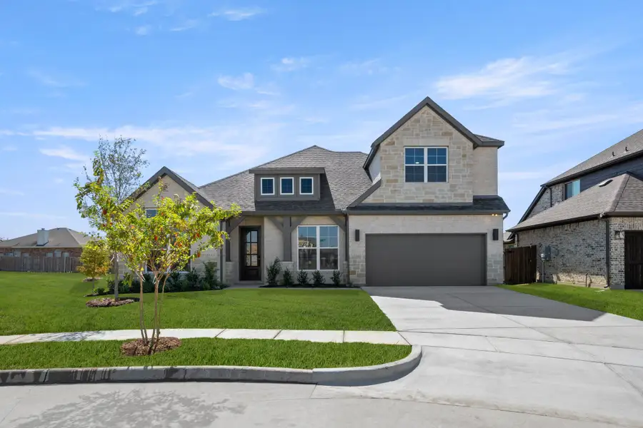 Front exterior of a new home in Panchasarp Farms, Burleson, TX, highlighting curb appeal (Image 1). Front exterior of a new home in Panchasarp Farms, Burleson, TX, highlighting curb appeal (Image 1).