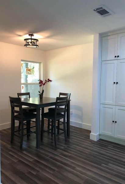 Dining room featuring dark wood-type flooring