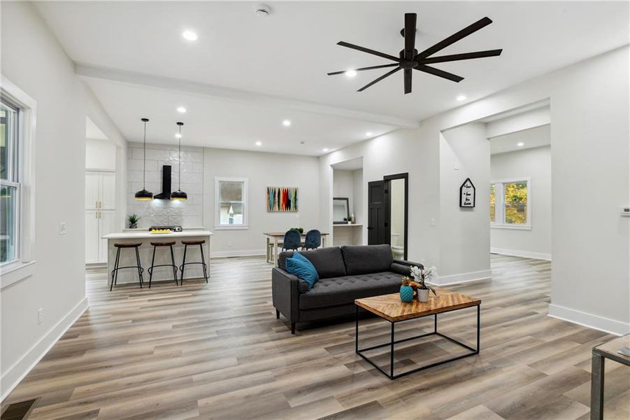 Living room featuring ceiling fan and Luxury Vinyl Plank flooring