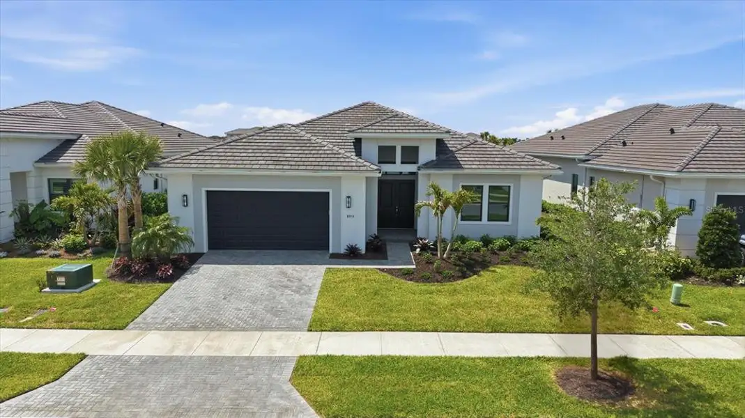 Front exterior of a new home in , Sarasota, FL, highlighting curb appeal (Image 2).