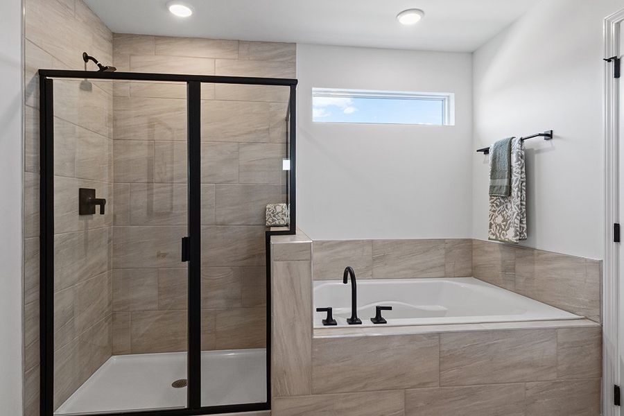 A bathroom with a bathtub and shower.