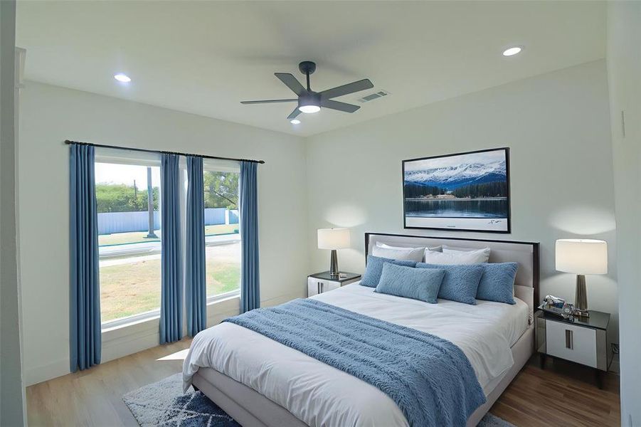 Bedroom featuring light wood-type flooring, ceiling fan, and recessed lighting Bedroom featuring light wood-type flooring, ceiling fan, and recessed lighting